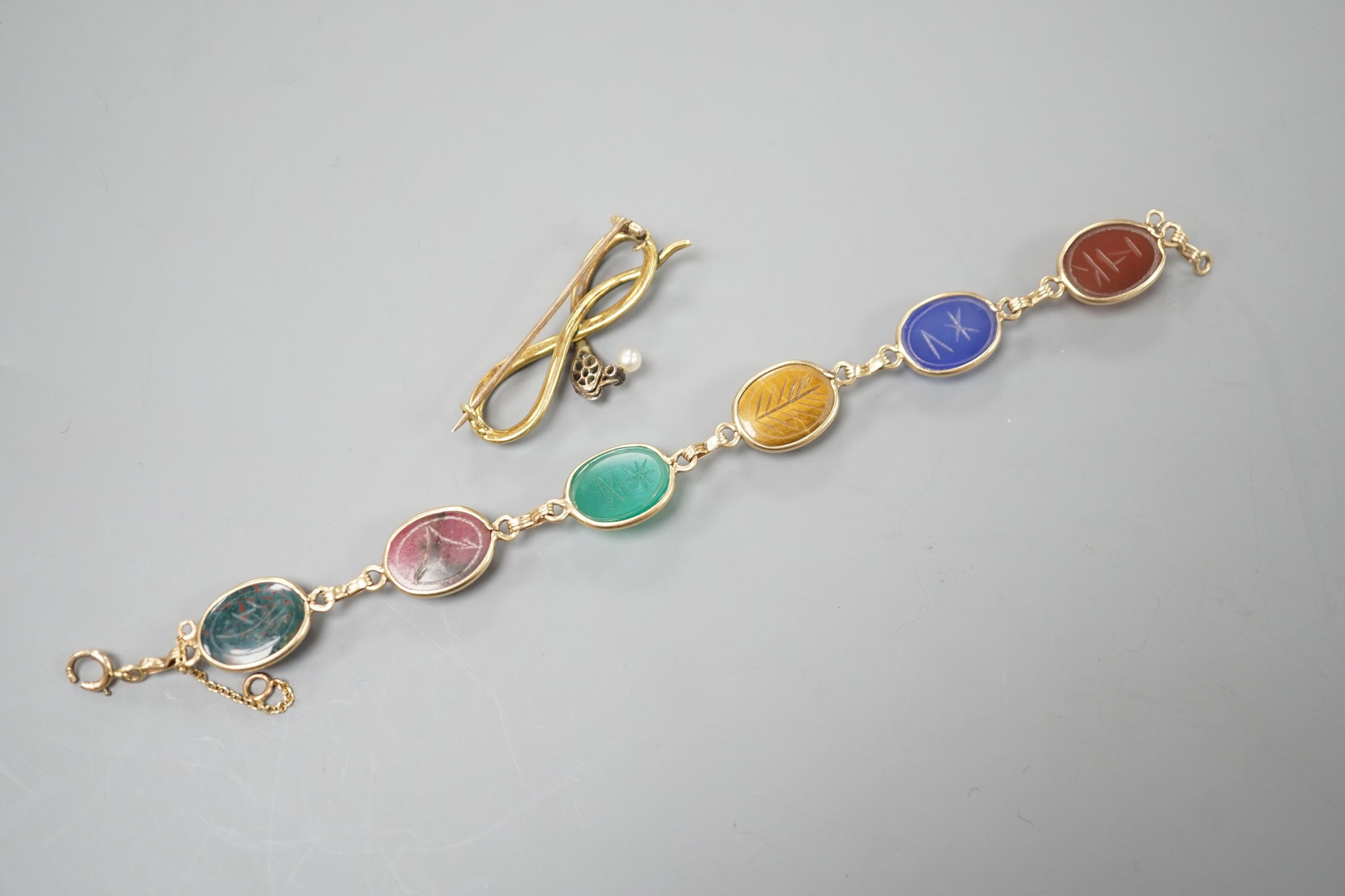 A 14k yellow metal and six stone multi gem set 'scarab' bracelet, 18.5cm, gross 15.4 grams and a yellow metal, diamond, drop pearl and green enamel set serpent brooch, gross 7.5 grams.